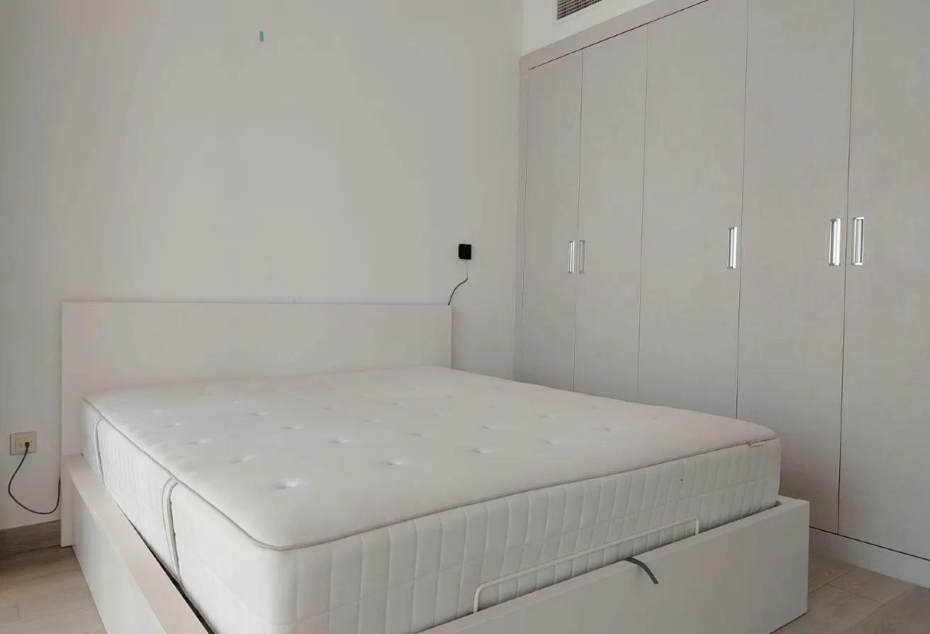 Bloom Towers JVC — living and dining area with balcony view