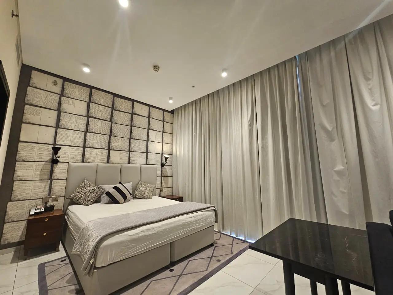 Millennium Atria Business Bay — bedroom with curtains and window
